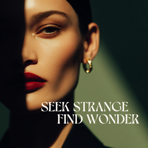 Close-up of a woman's face with red lipstick and gold earrings, text 'Seek Strange Find Wonder' below.